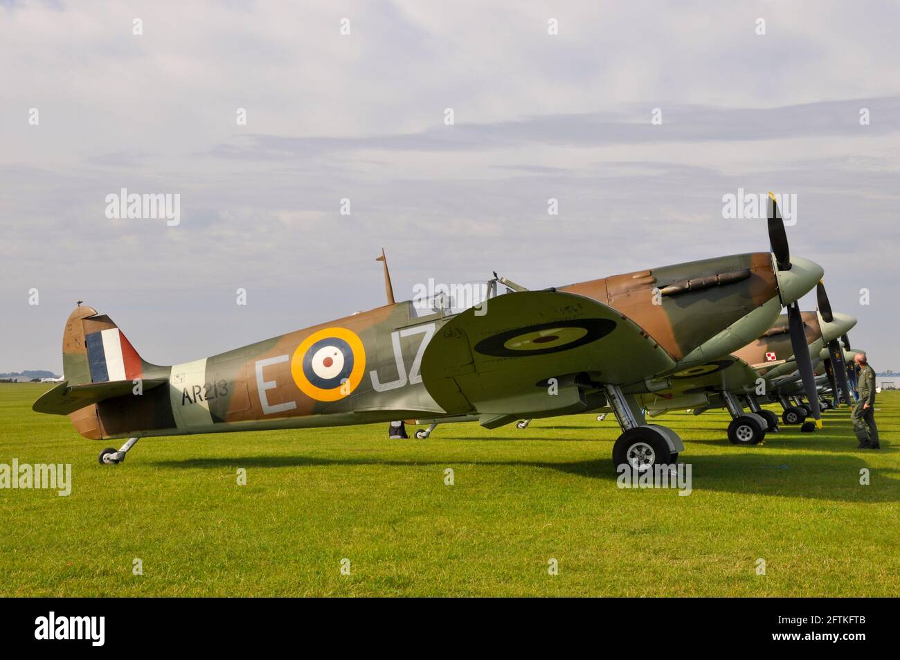 Vickers Supermarine Spitfire Mk.I fighter plane AR213 heading a line of Second World War fighter planes at Duxford, Cambridgeshire, UK. Stock Photo