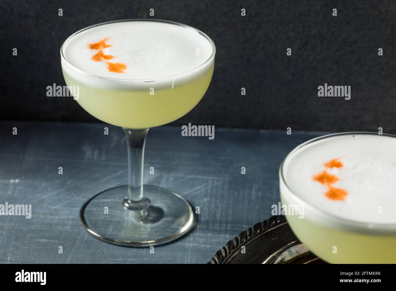 Refreshing Cold Pisco Sour Cocktail with Lime and Egg Whites Stock Photo