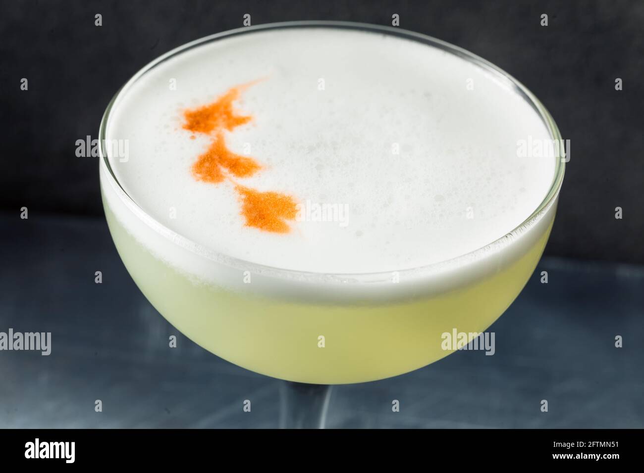 Refreshing Cold Pisco Sour Cocktail with Lime and Egg Whites Stock