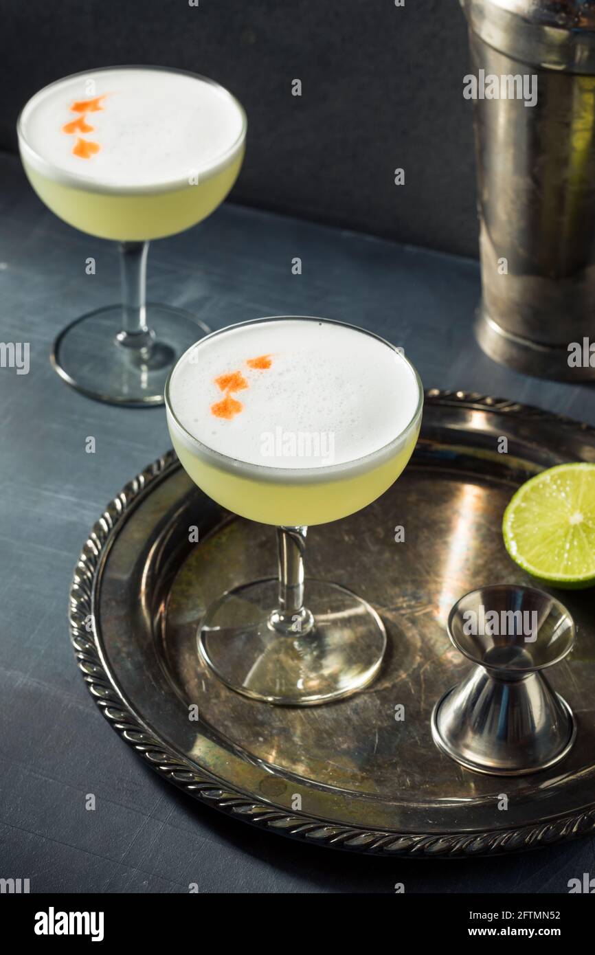 Refreshing Cold Pisco Sour Cocktail with Lime and Egg Whites Stock