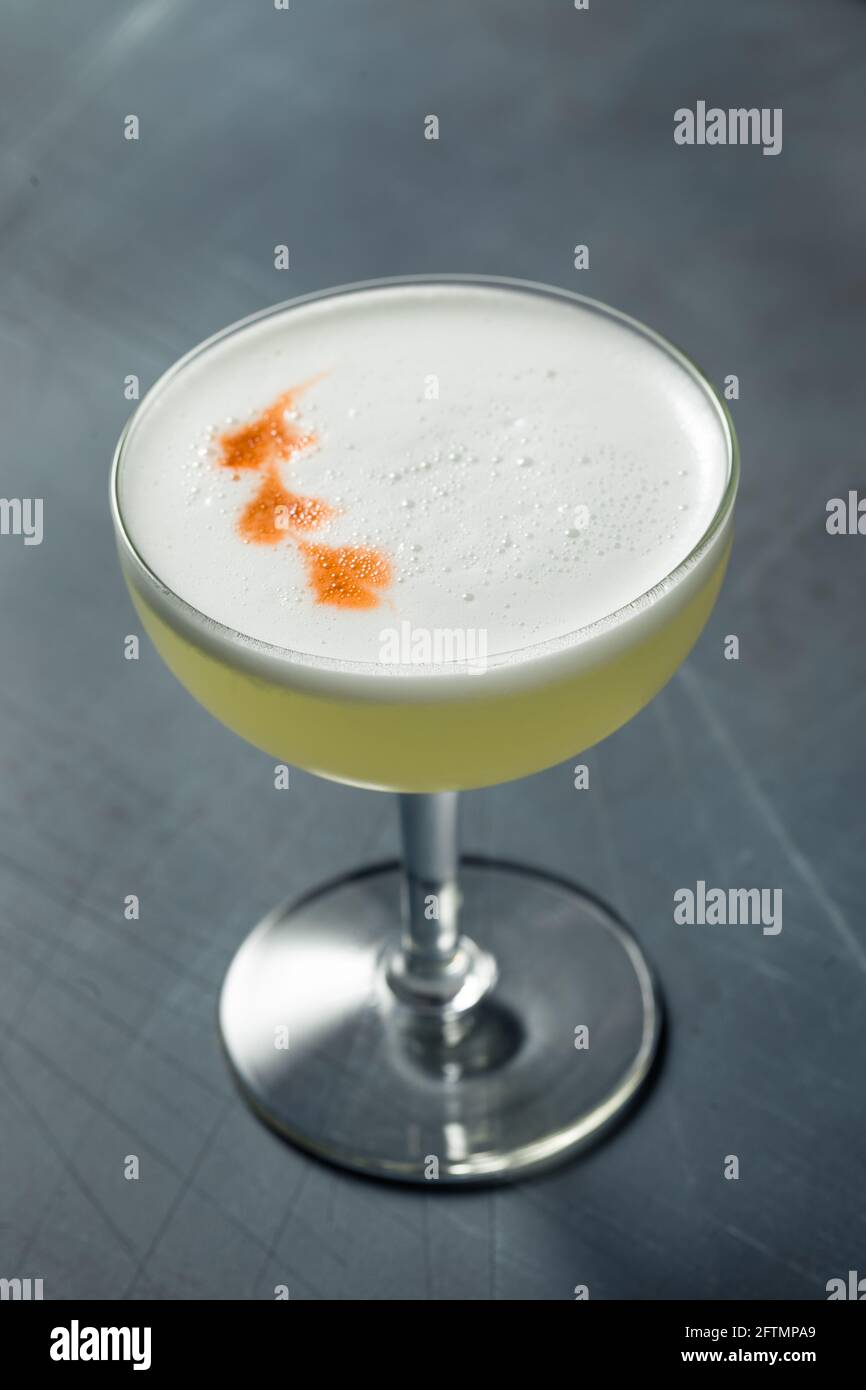 Refreshing Cold Pisco Sour Cocktail with Lime and Egg Whites Stock Photo