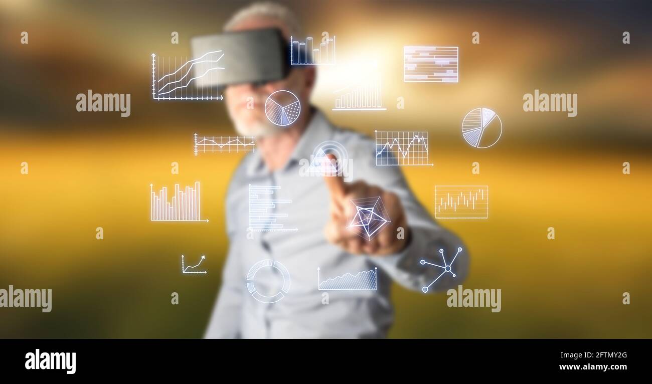 Man wearing a reality virtual headset touching business charts on a ...