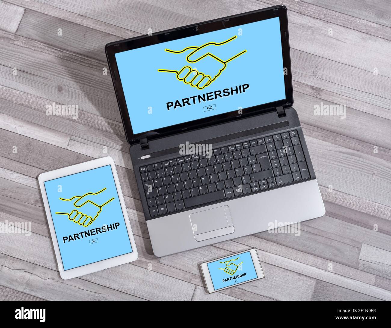 Partnership concept shown on different information technology devices Stock Photo