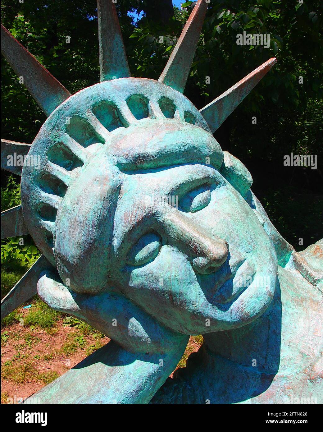 New York, New York, USA. 21st May, 2021. Artist Zaq Landsberg's sculpture entitled ''Reclining Liberty'' inside Morningside Park in New York City .The sculpture was created by Landsberg and features the Statue of Liberty posed on her side with her head propped up by her hand. The 25 foot long sculpture is covered in oxidized copper paint and features a steel crown and was created using wood, foam and plaster resin. Credit: Debra L. Rothenberg/ZUMA Wire/Alamy Live News Stock Photo