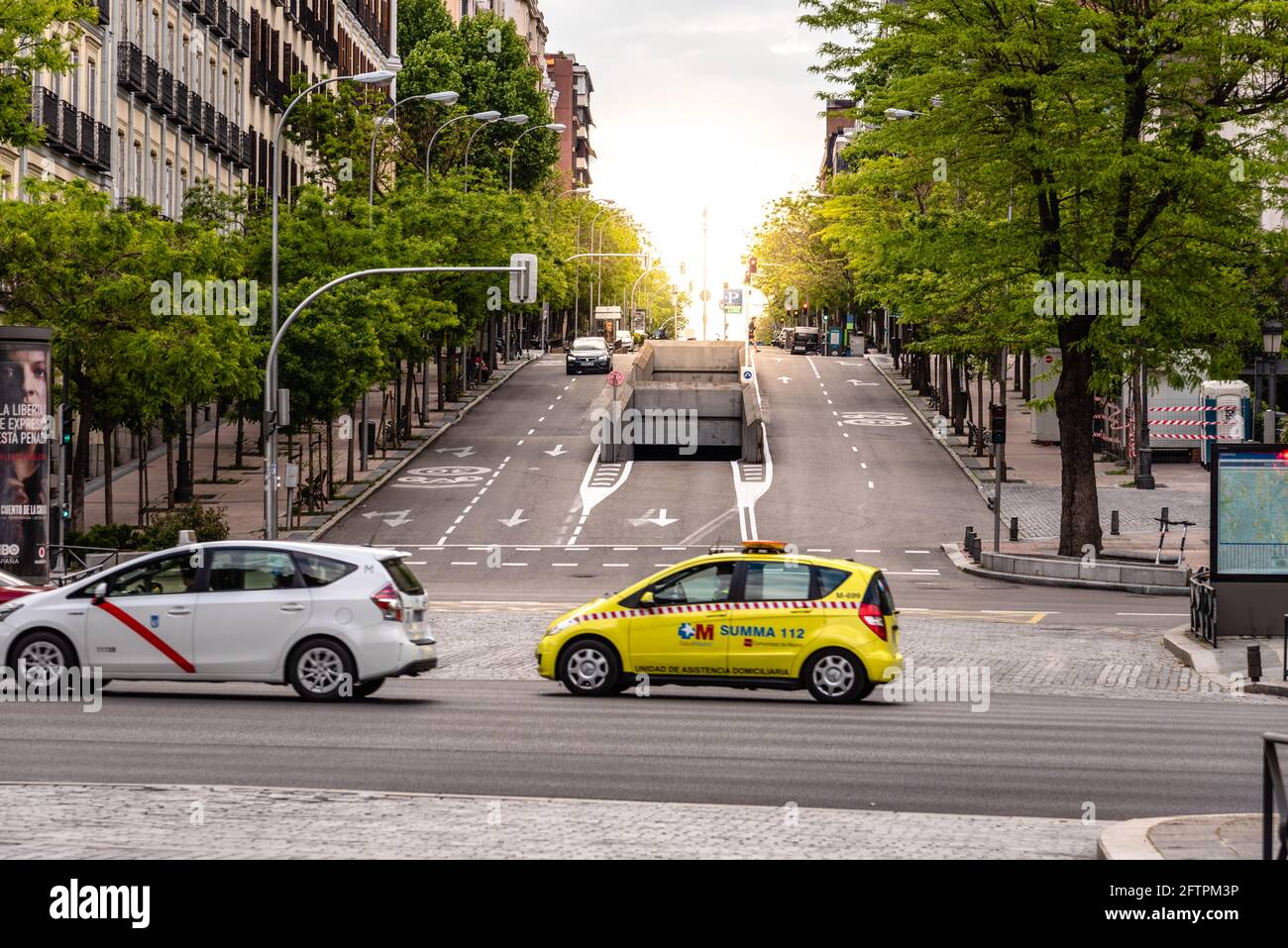 Madrid, Spain - May 1, 2021: Summa 112 health services car crossing Castellana Avenue in Madrid during covid-19 pandemic in the early morning. Sun ove Stock Photo