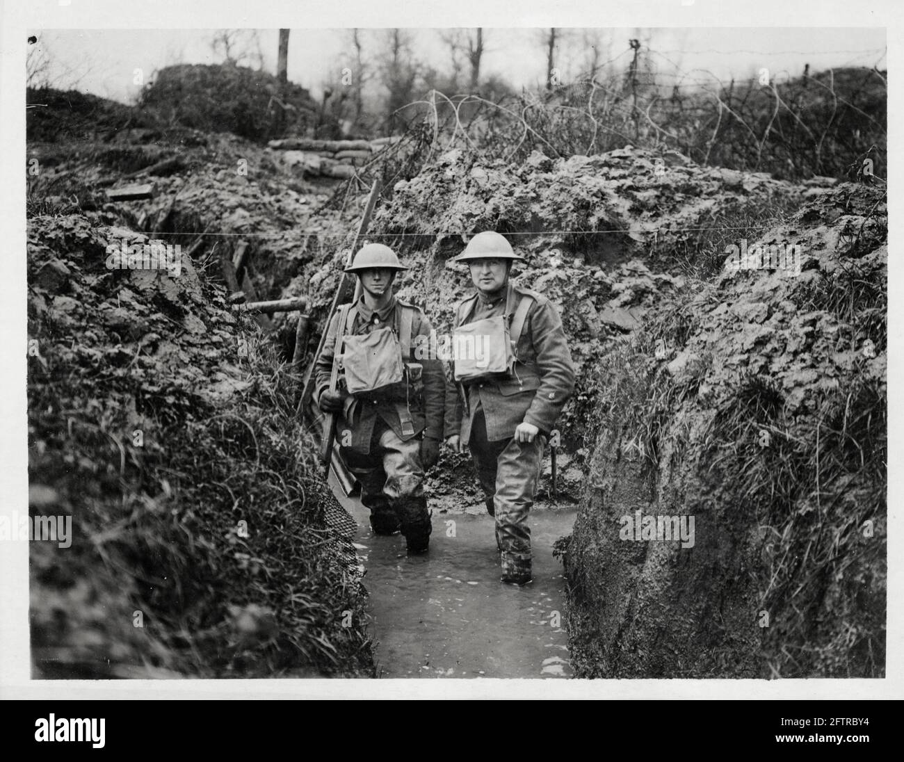 World War One, WWI, Western Front - Two men in a flooded communication trench, France Stock Photo