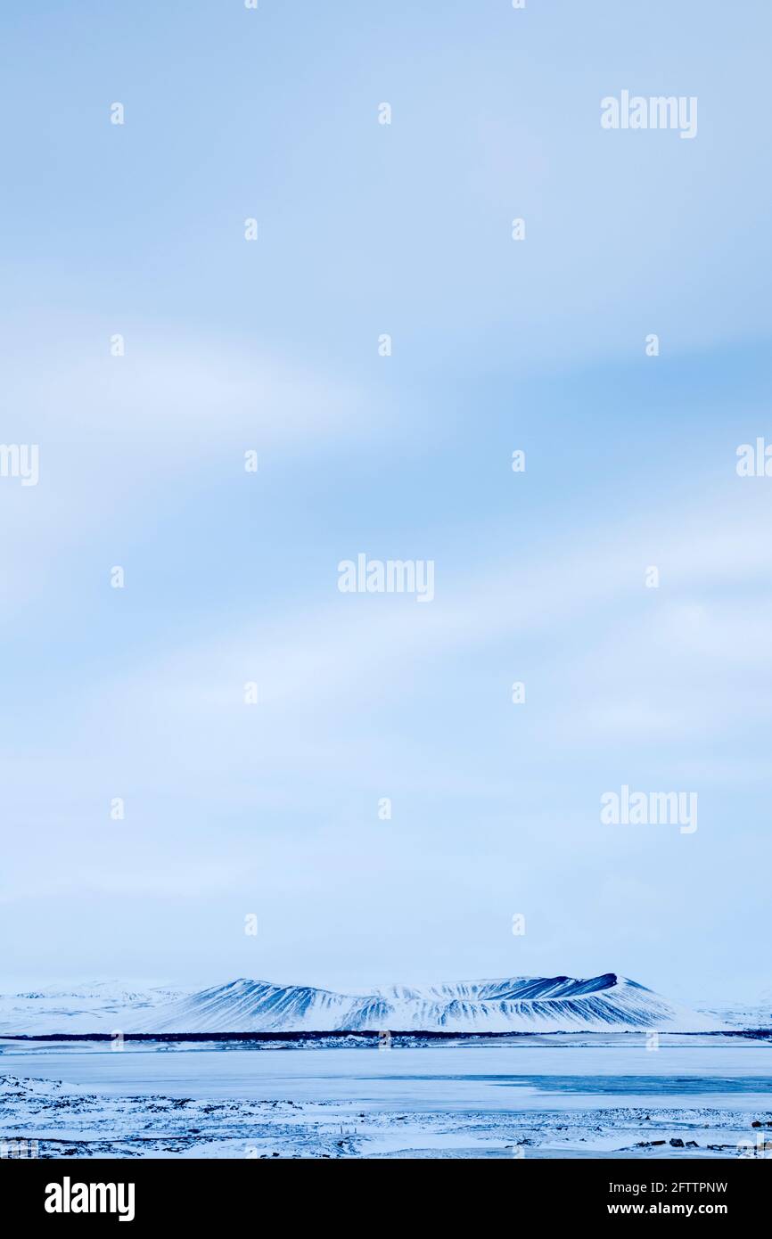 Hverfjall volcano snow covered in winter viewed from across a frozen lake Myvatn Stock Photo