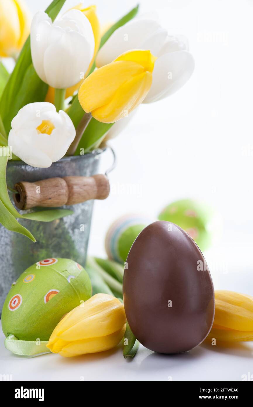 Chocolate and colorful Easter eggs and tulip flowers Stock Photo - Alamy