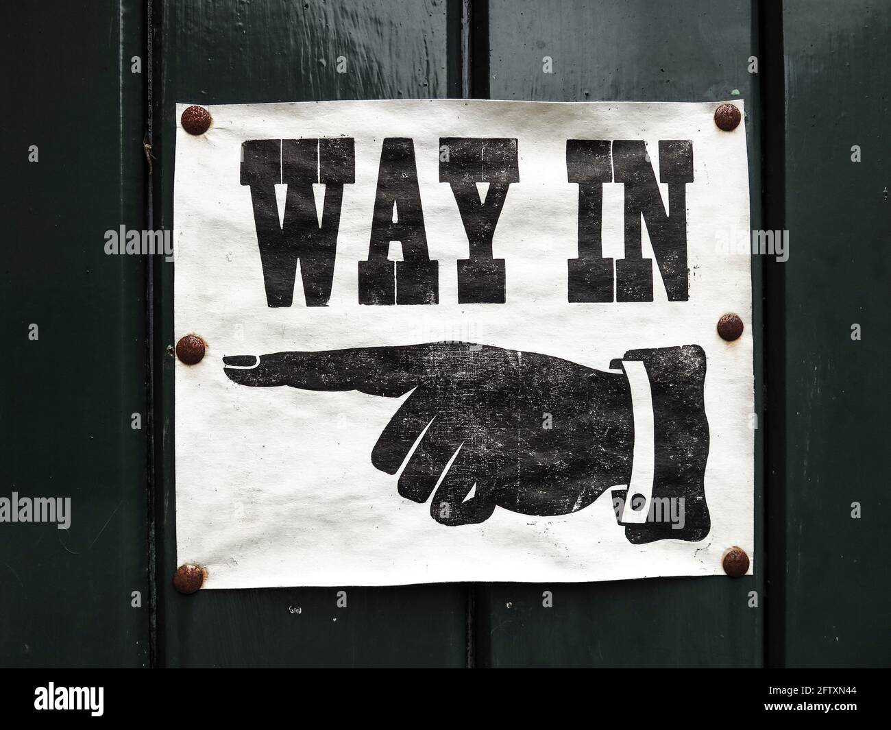 Old style way in sign with pointing hand Stock Photo