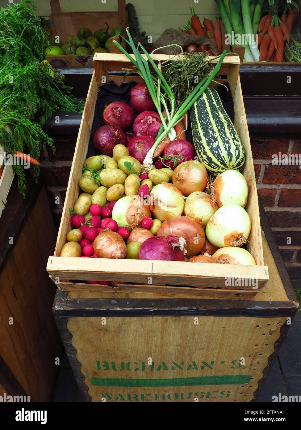 Old fashioned style greengrocers display of fresh vegetables outside shop Stock Photo