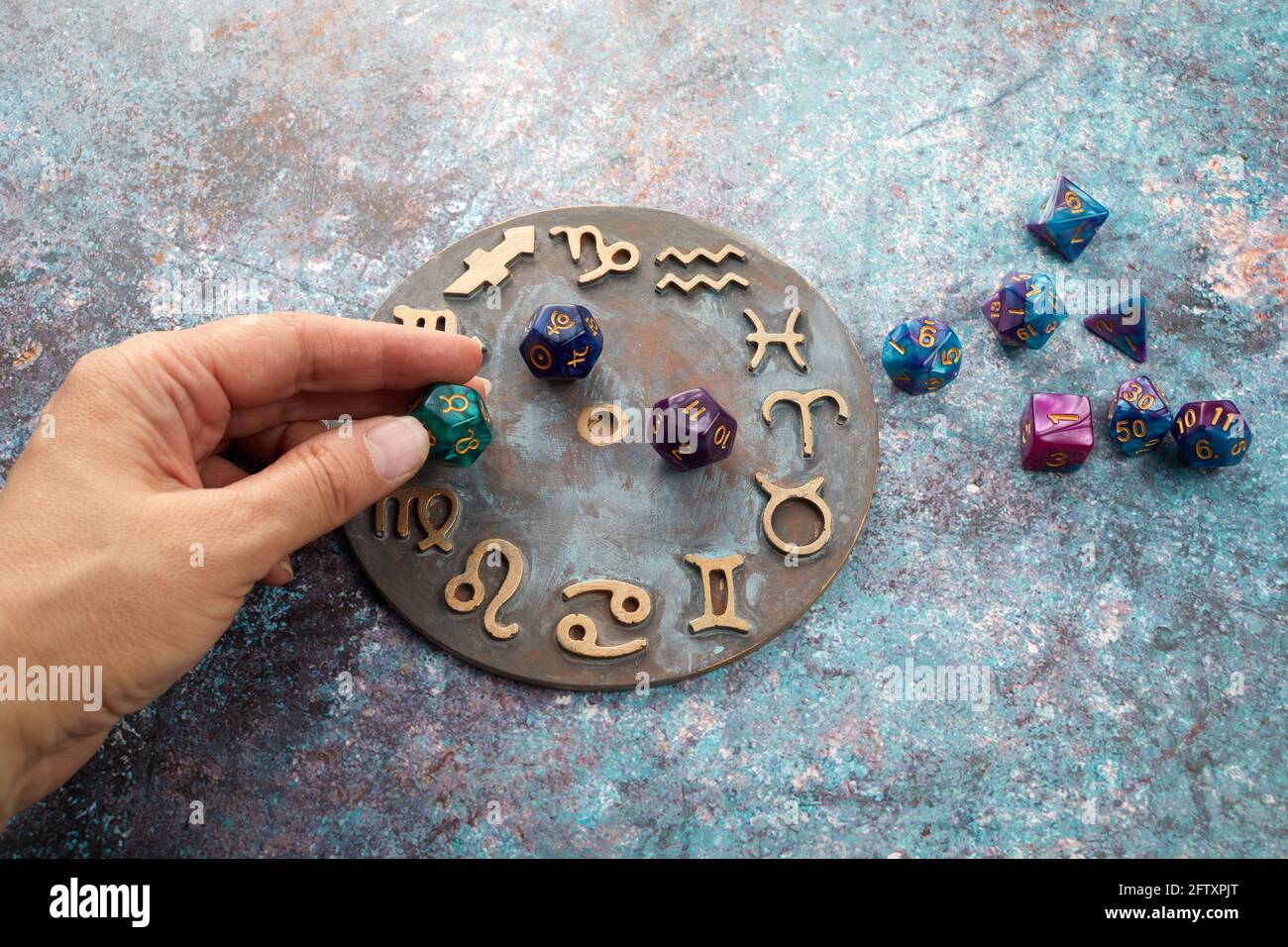 zodiac horoscope symbol with hands and healing crystals on rustic background
