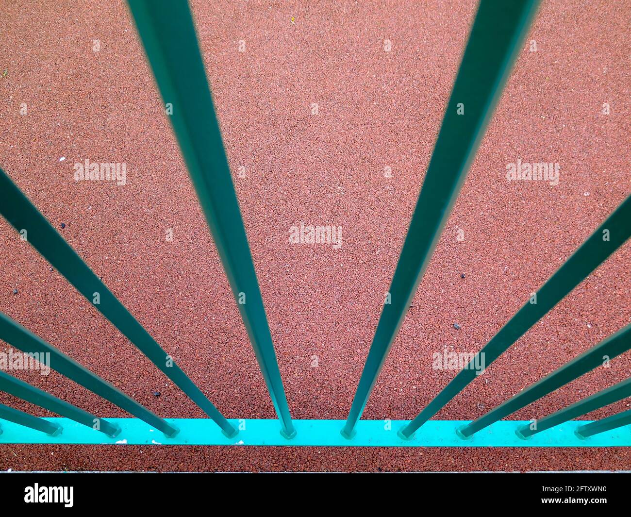 Green railings against red background abstract Stock Photo