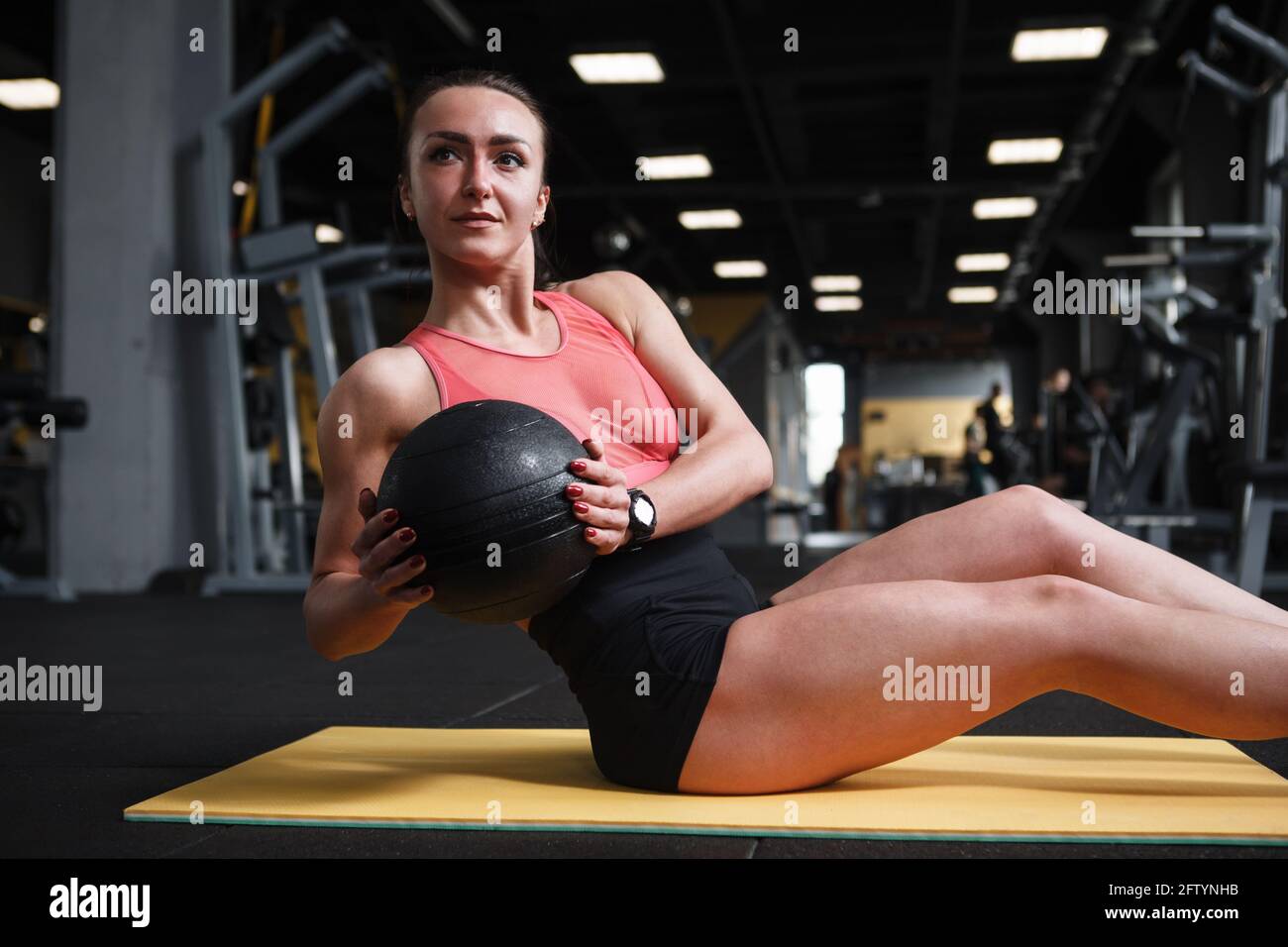 Happy healthy strong woman doing russian twist abs workout with