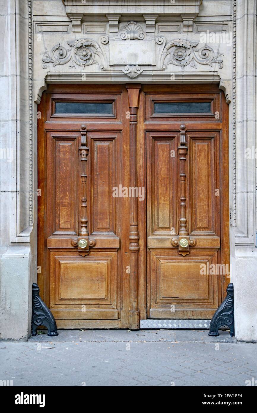 Carved wooden double door, commonly found as entrance to European apartment buildings Stock Photo