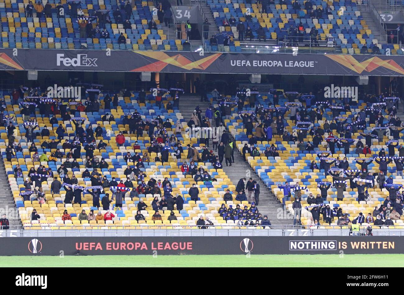 KYIV, UKRAINE - MARCH 11, 2021: Tribunes of NSK Olimpiyskiy stadium in Kyiv one third full due to COVID-19 quarantine restrictions seen during UEFA Europa League game Dynamo Kyiv v Villarreal Stock Photo