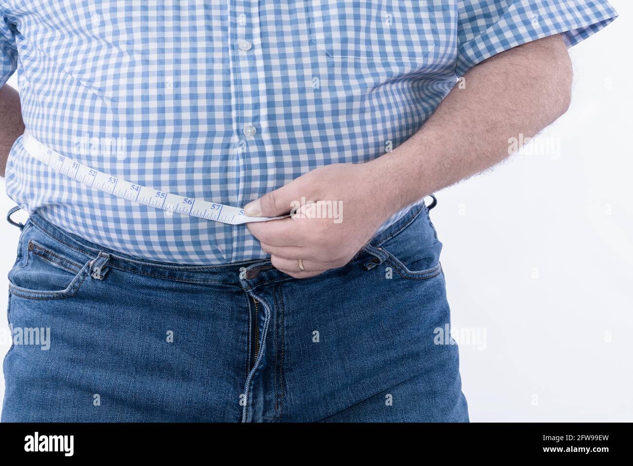 Fat man check out his body fat with measuring tape Selective focus