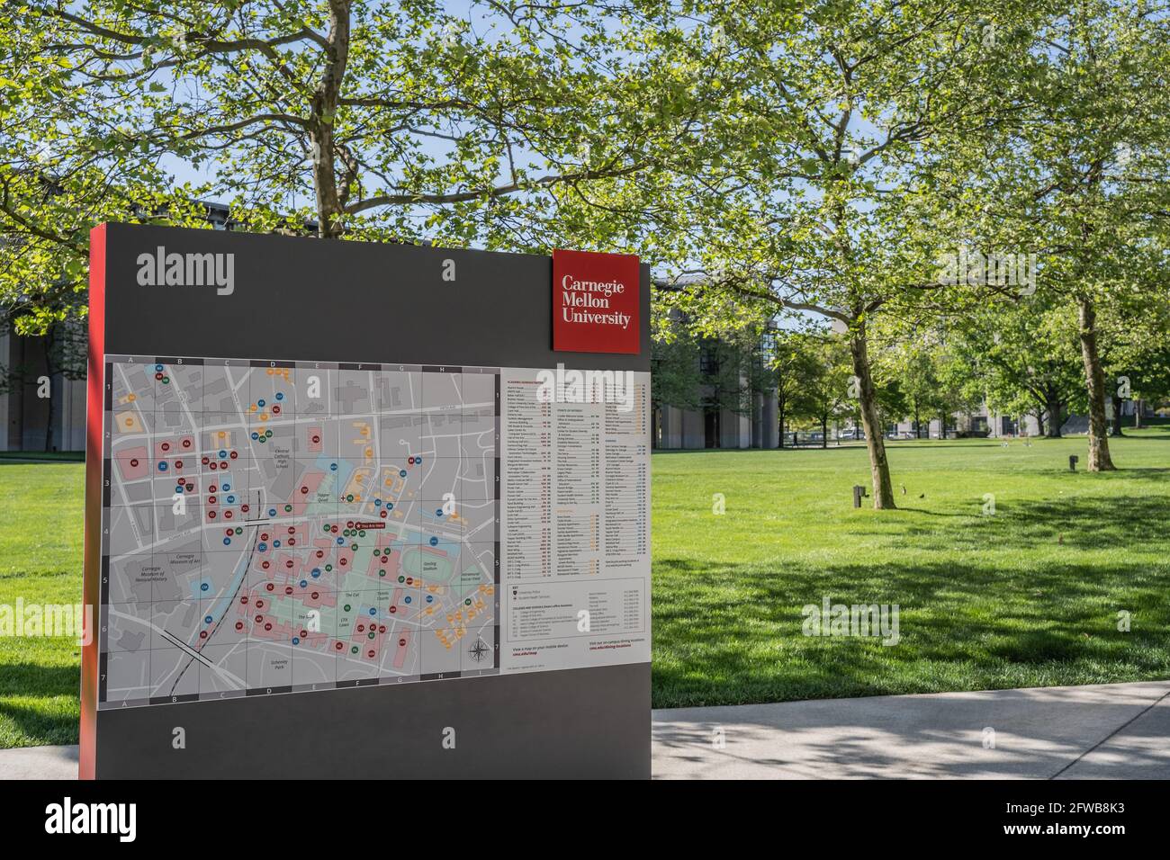 Pittsburgh, Pennsylvania, USA- May 13, 2021: Carnegie Mellon University map and sign with campus in the background Stock Photo