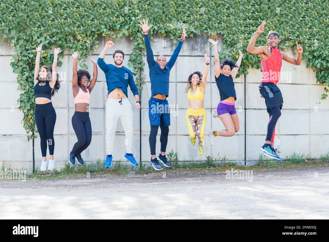 Group of runners jumping at the same time in a park Stock Photo - Alamy
