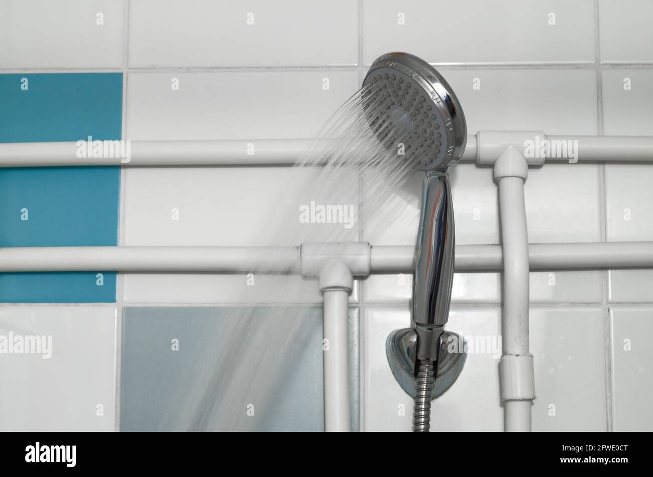 Silver shower head on a bathroom with water drops falling on a bathroom ...