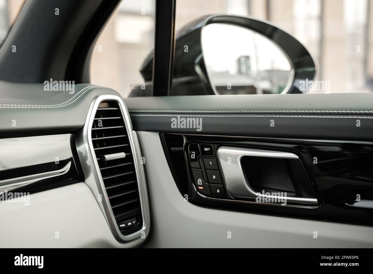 Dark car interior - ventilation system, door handle lock, side rearview mirror Stock Photo