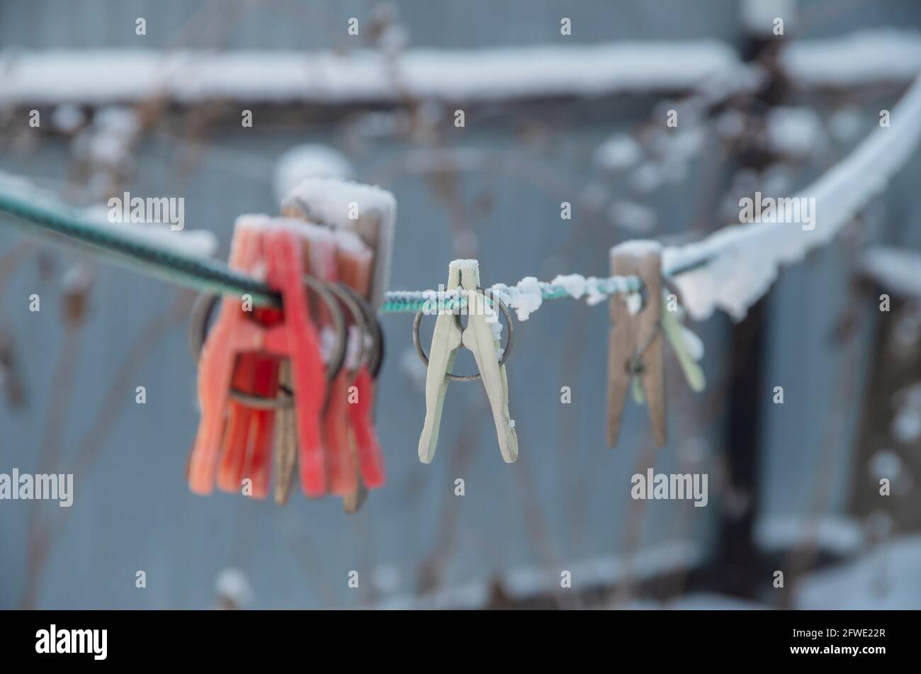 clothespins on a rope under the snow. Stock Photo
