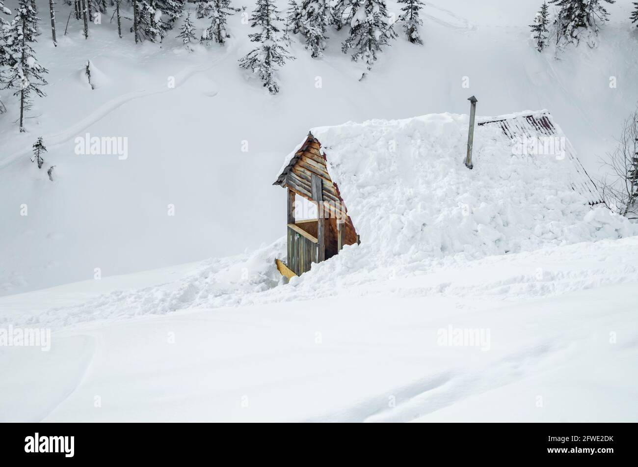 Minimalist winter landscape with wooden house in snowy mountains. landscape photography Stock Photo