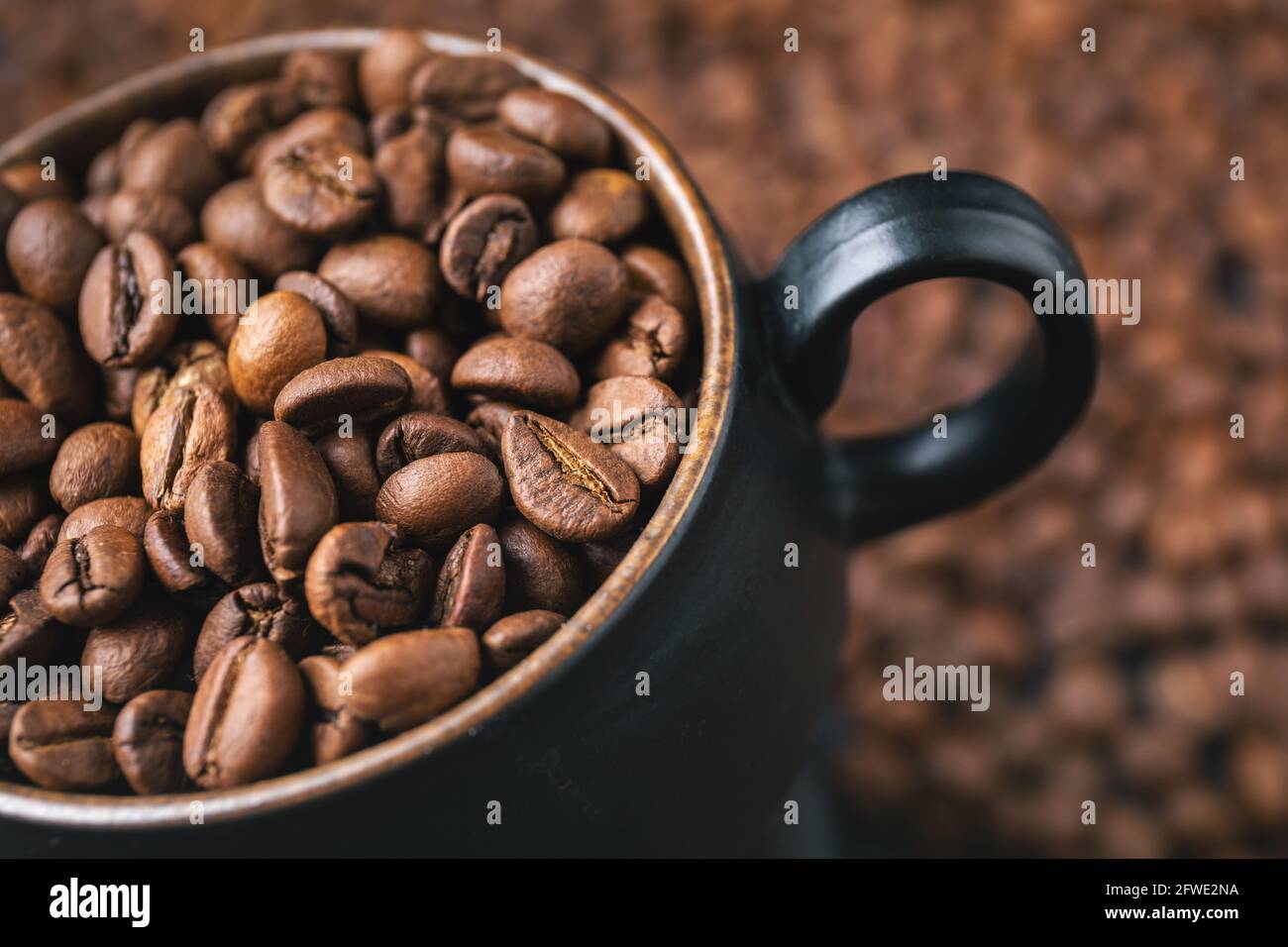 Coffee cup full with coffee beans, close up shoot. Coffee background concept. Stock Photo