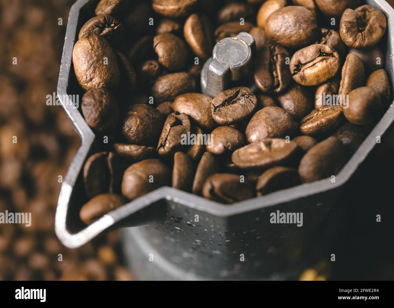 Top view on mocha pot full with coffee beans. Coffee background concept. Stock Photo