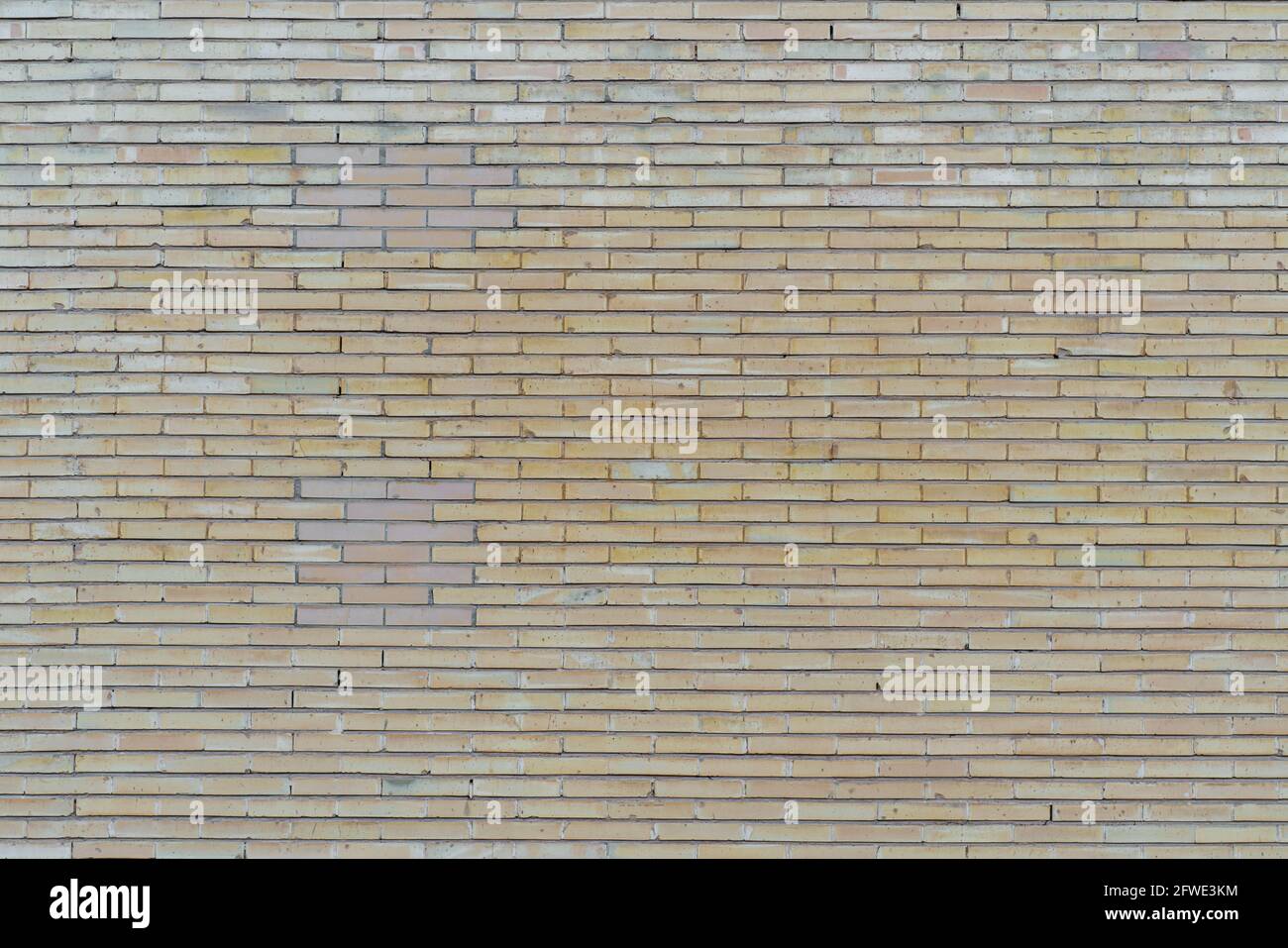 Brick-wall pattern in yellow, wallpaper, background. Stock Photo