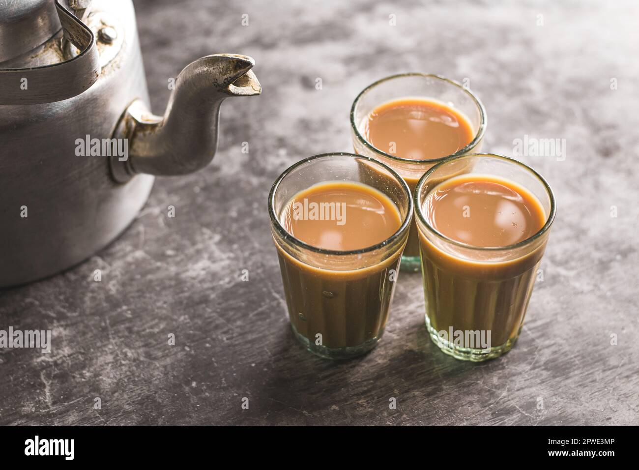 Indian chai in glass cups with metal kettle and other masalas to make the tea Stock Photo - Alamy Indian chai in glass cups with metal kettle and other masalas to make the tea Stock Photo - Alamy