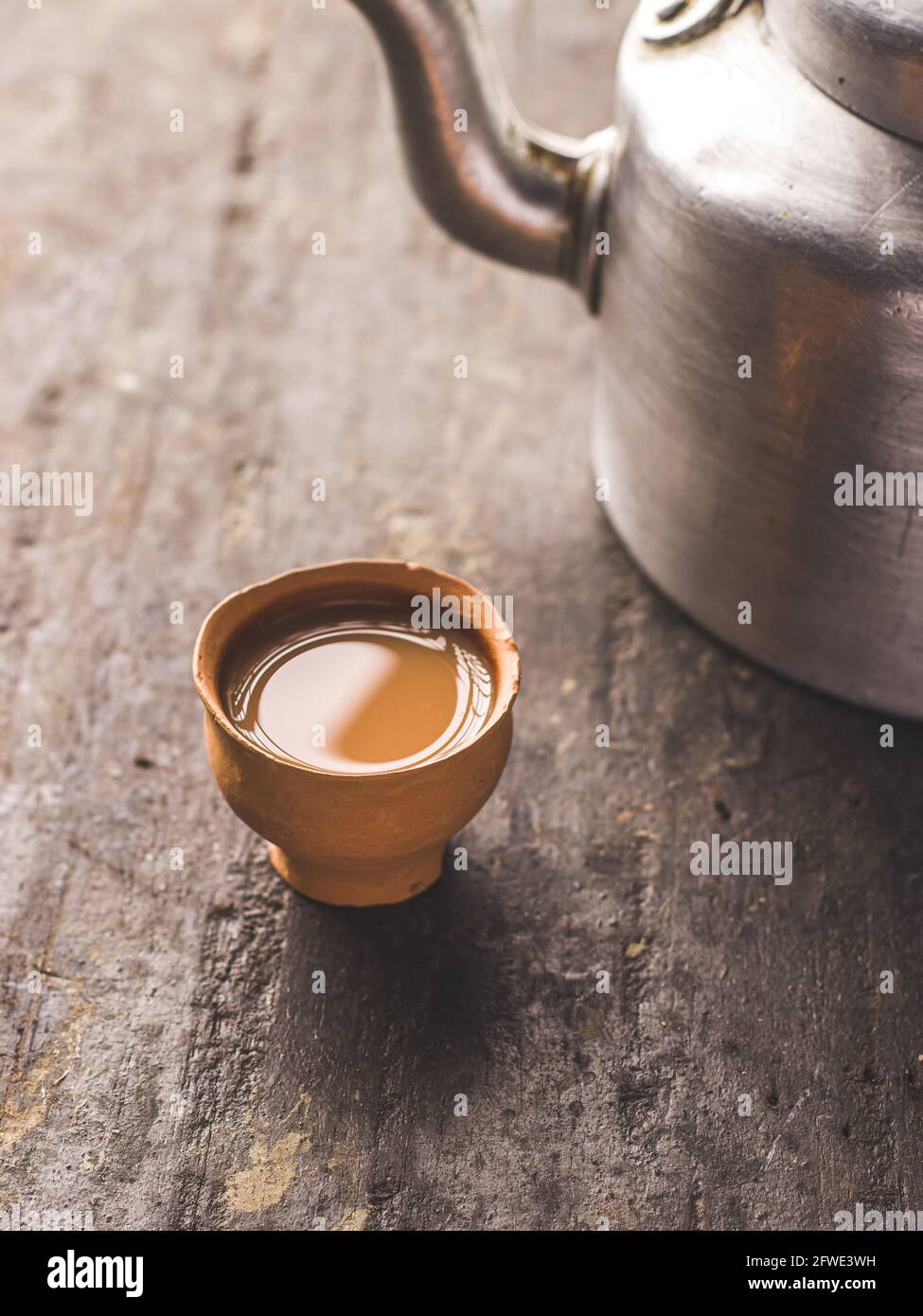 Indian chai in glass cups with metal kettle and other masalas to make