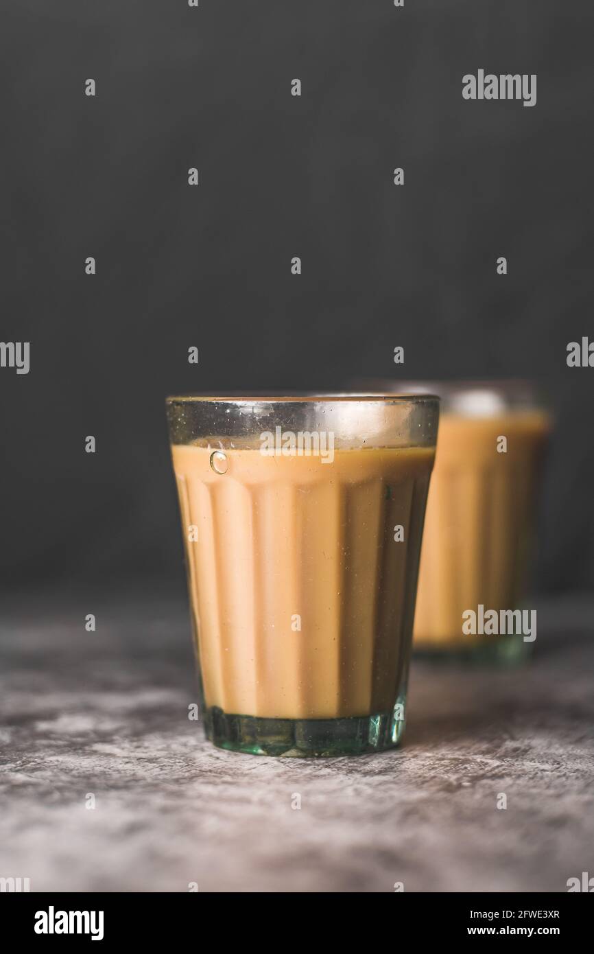 https://c8.alamy.com/comp/2FWE3XR/indian-chai-in-glass-cups-with-metal-kettle-and-other-masalas-to-make-the-tea-2FWE3XR.jpg