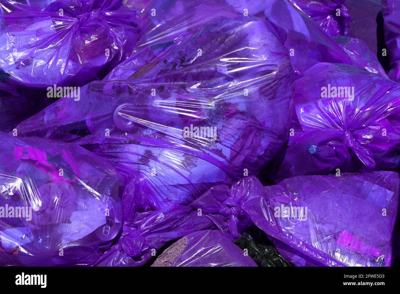 full frame background of purple plastic trash bags with generic domestic  waste Stock Photo - Alamy
