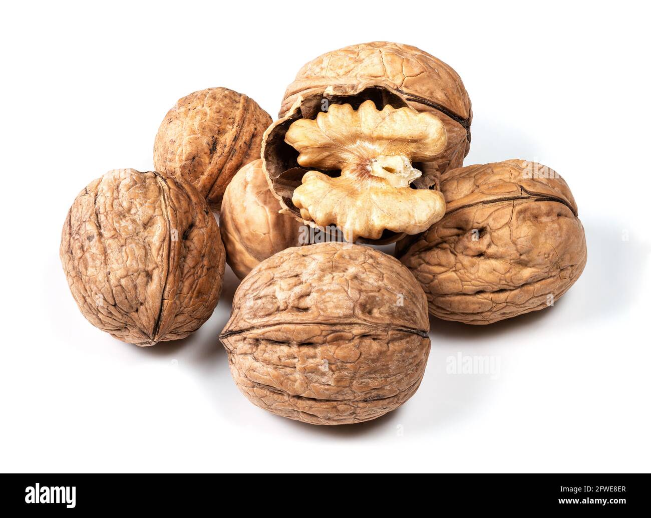 several whole and shelled walnuts closeup on white background Stock Photo