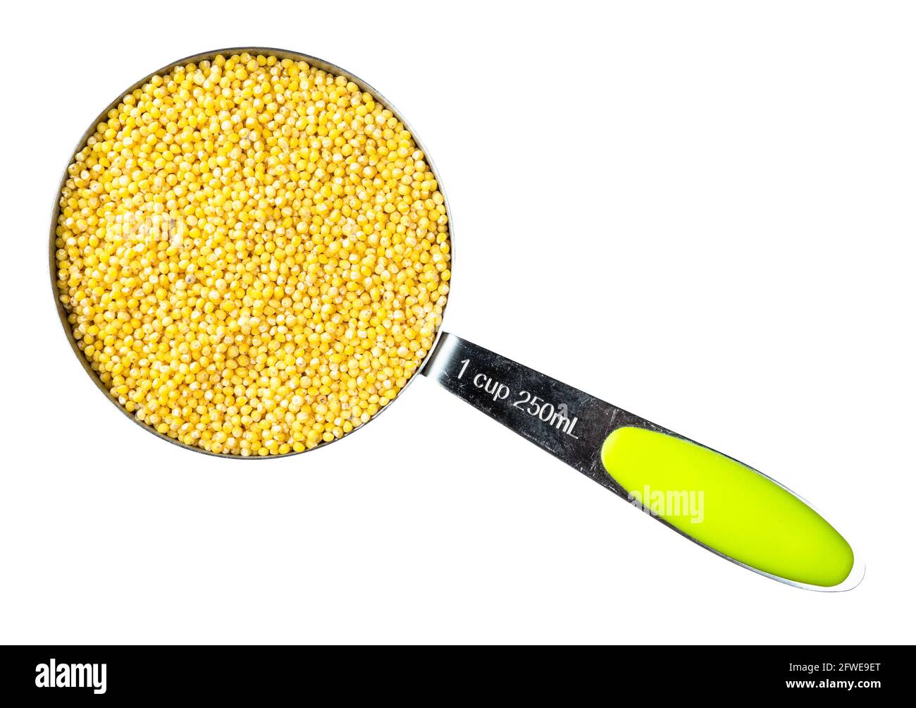 top view of millet groats from husked proso millet in measuring cup ...