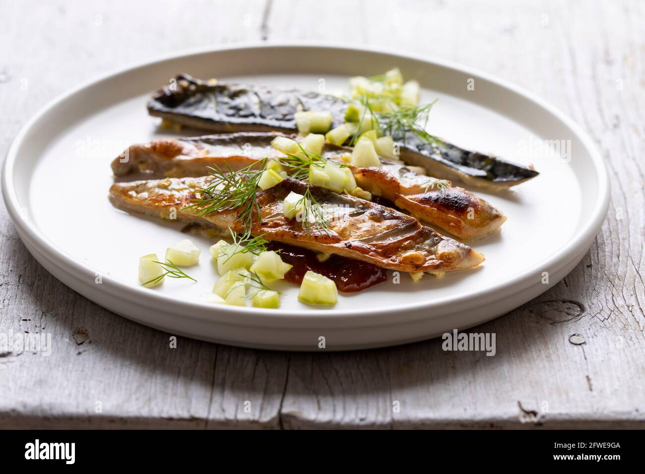 Grilled mackerel with gooseberry chutney and pickled cucumber Stock Photo