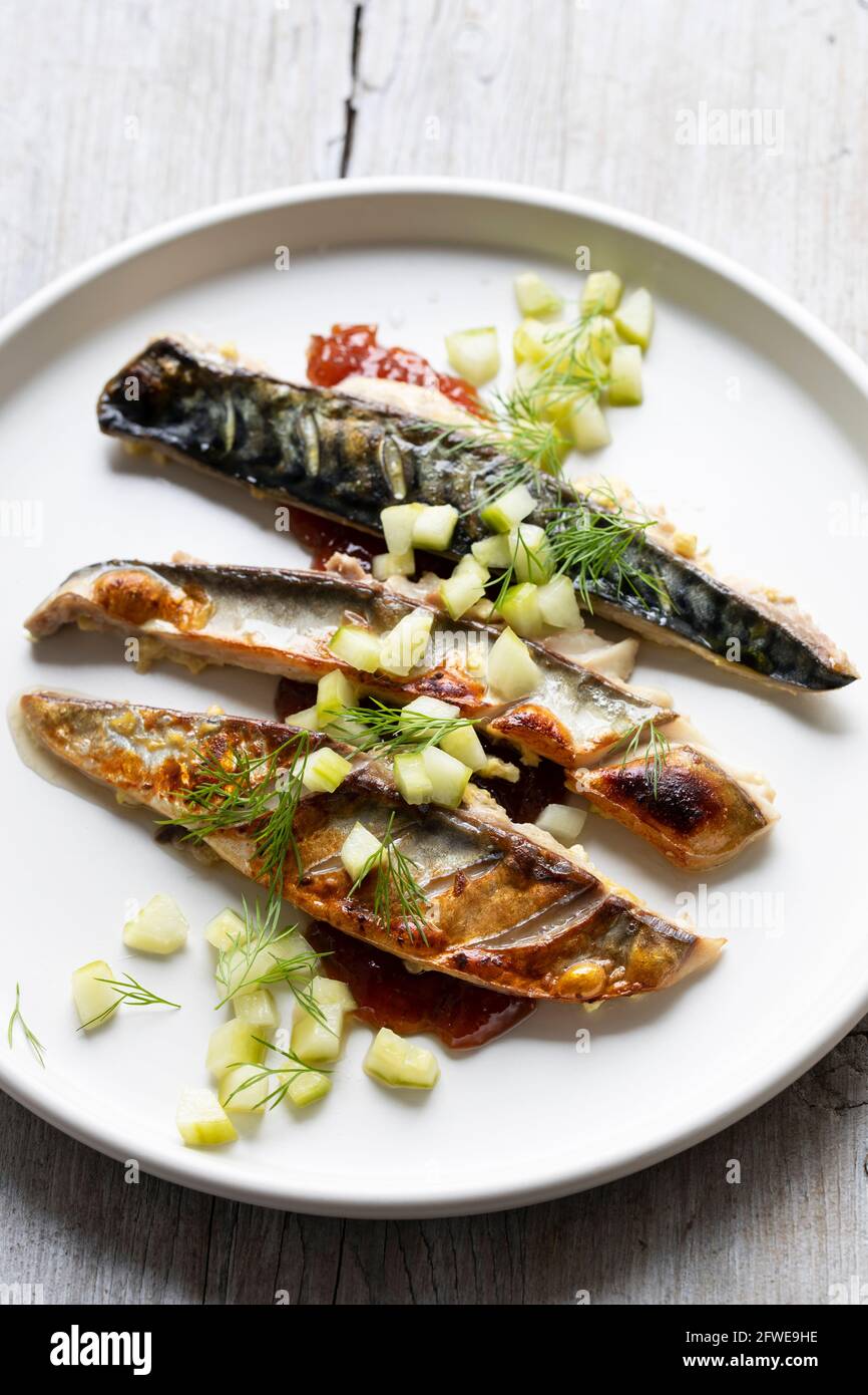 Grilled mackerel with gooseberry chutney and pickled cucumber Stock Photo