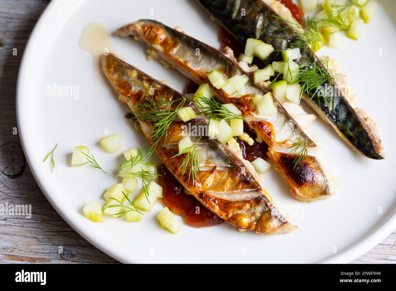 Grilled mackerel with gooseberry chutney and pickled cucumber Stock Photo