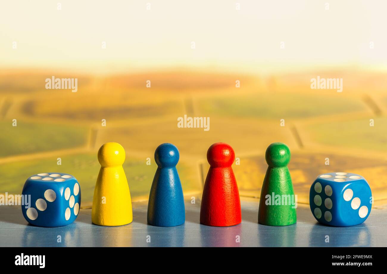 Two blue dices and colored chips on game board Stock Photo