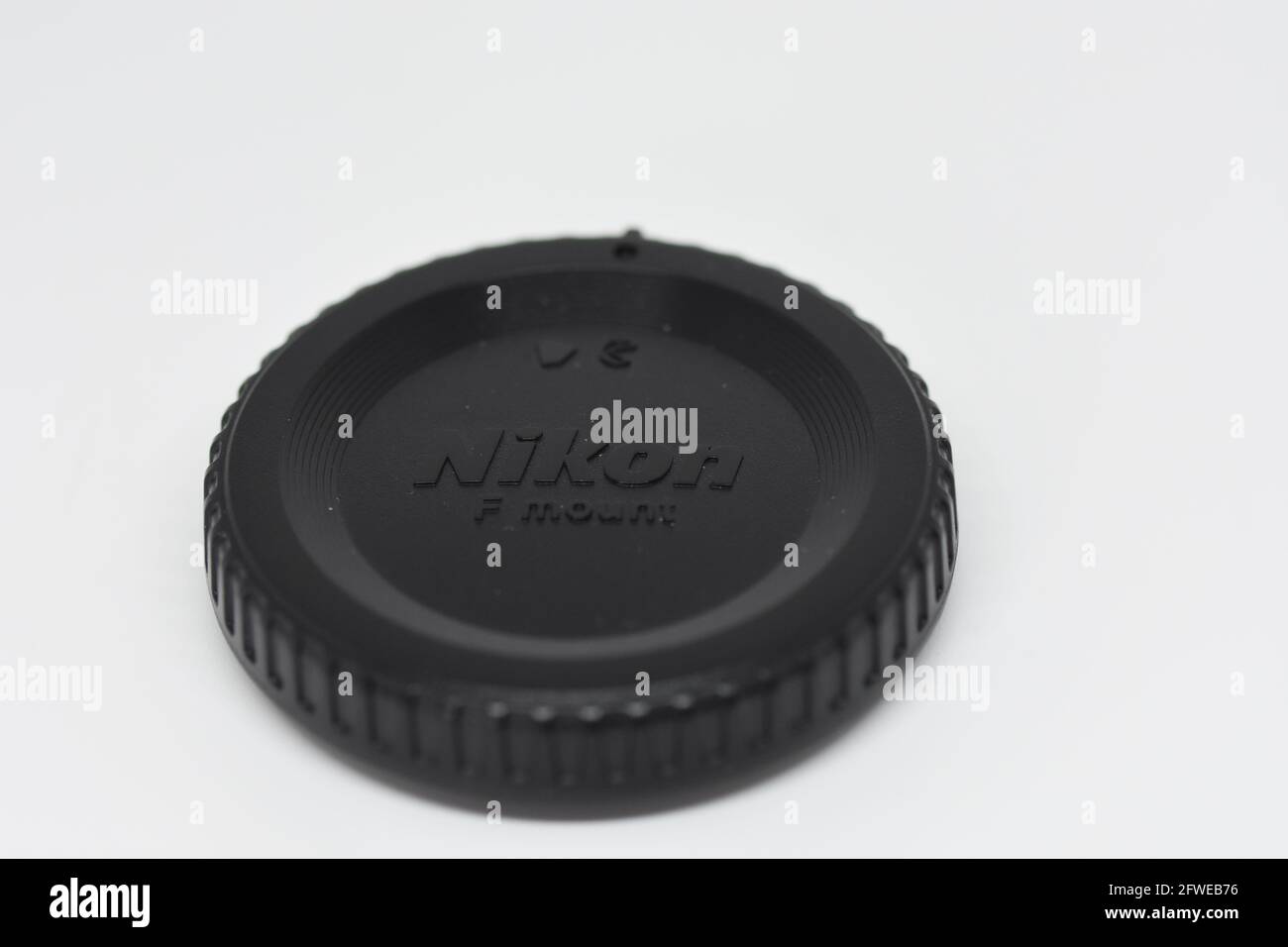 A camera cap/cover from a Nikon D3400 DSLR on a clean white background