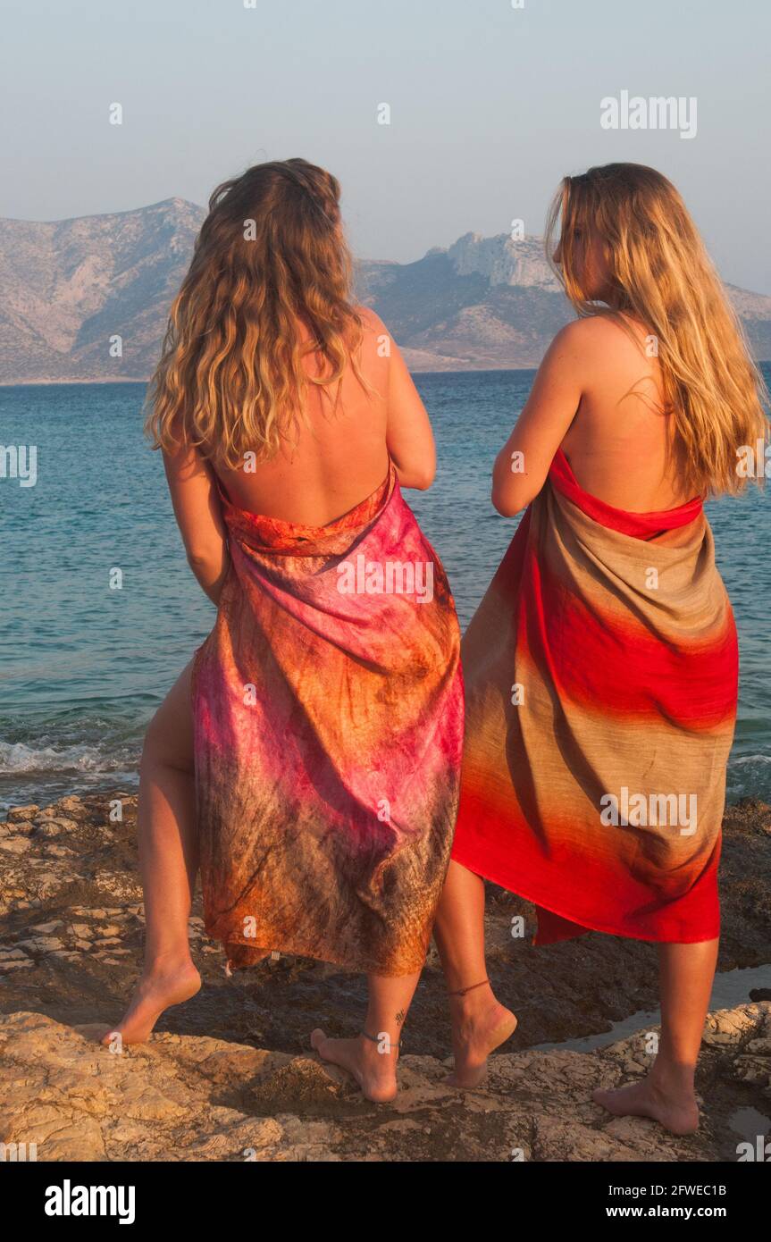 Girls, pose, sunset, sea, mountains, landscape, Koufonissia, Greece, Europe Stock Photo