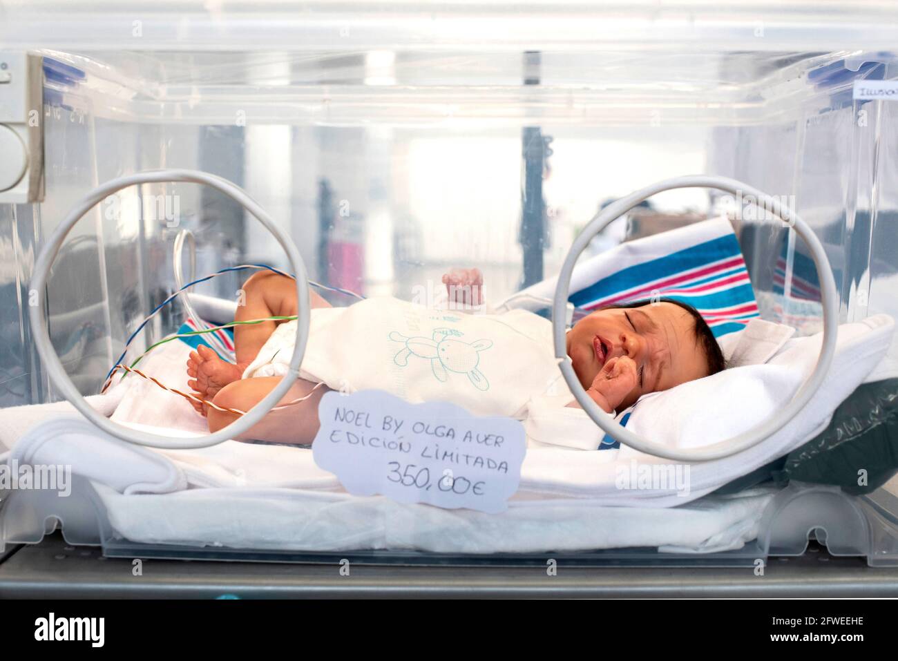 SPAIN, VALENCIA 2019-04-28. A reborn baby in his incubator if the realism of reborn babies is pushed to the extreme, the staging also allows to seduce Stock Photo