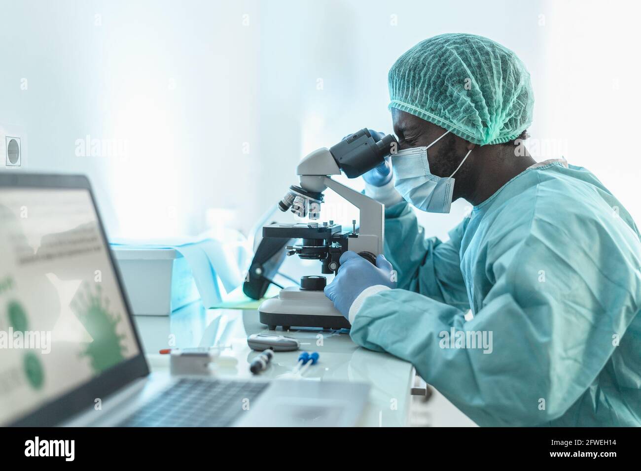 African doctor working in research lab examining through