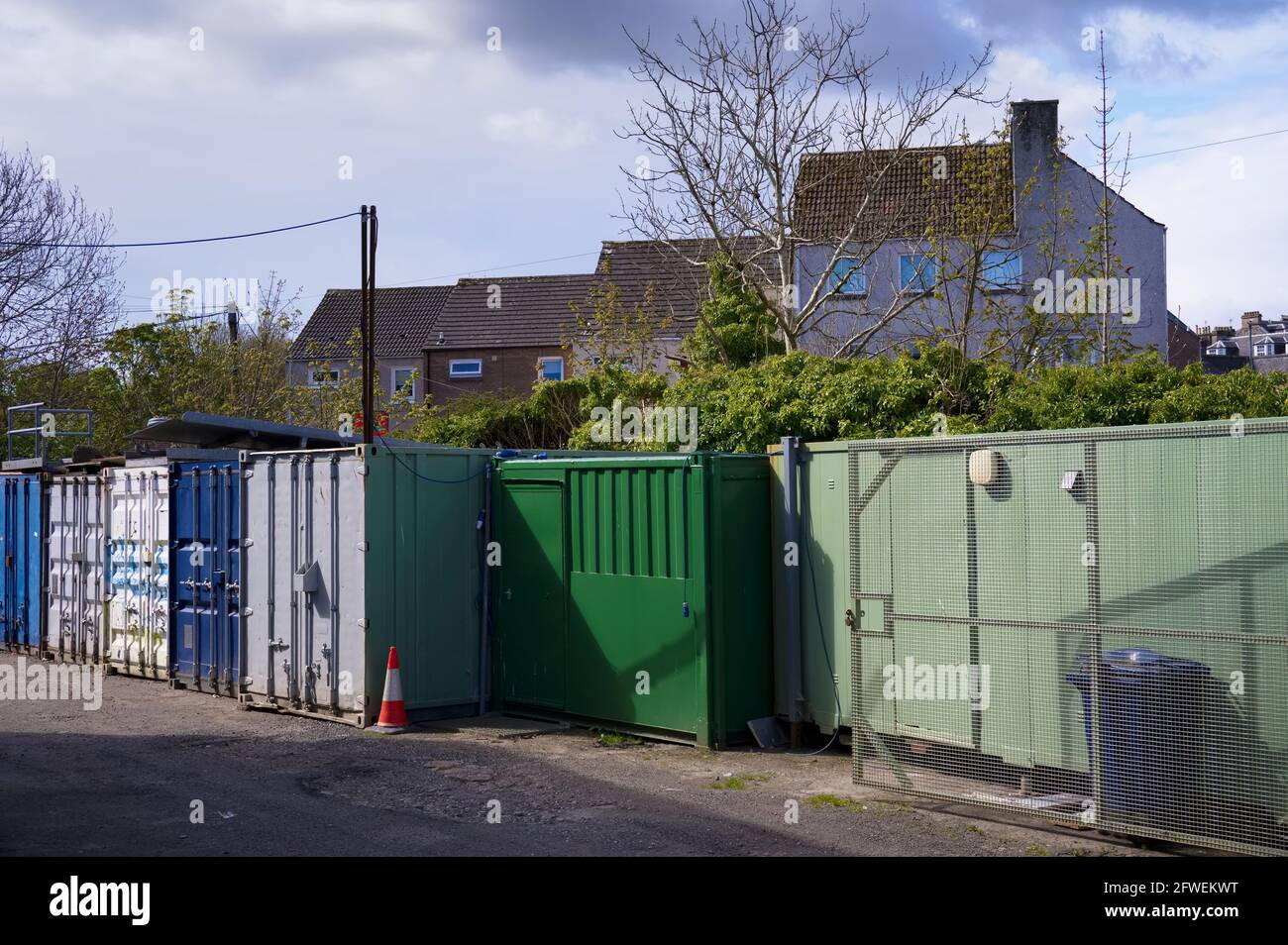 Green storage containers next to council house estate Stock Photo Alamy