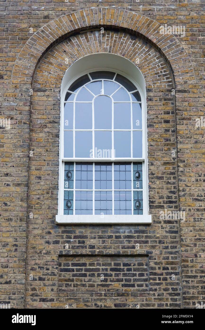 Arched brickwork and window with white frame Stock Photo Alamy