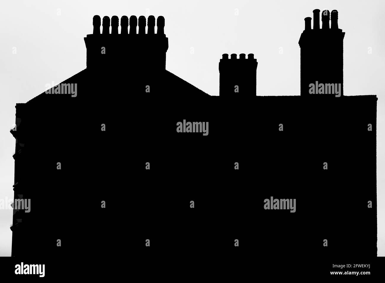 Silhouette of chimneys and rooftop of period building Stock Photo