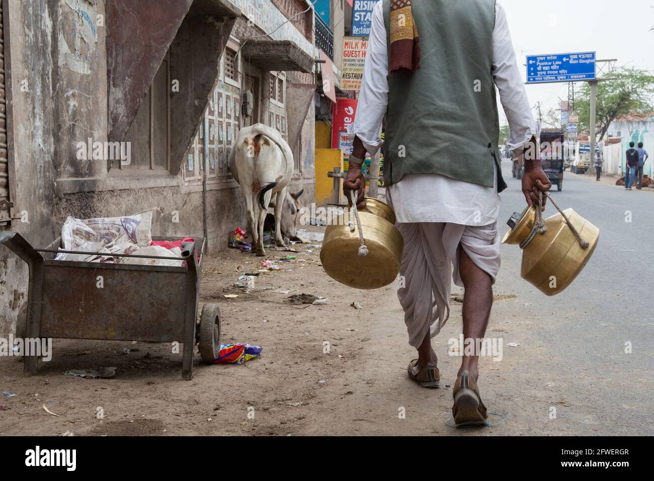 A man carrying water pots in Pushkar, Rajasthan, India Stock Photo