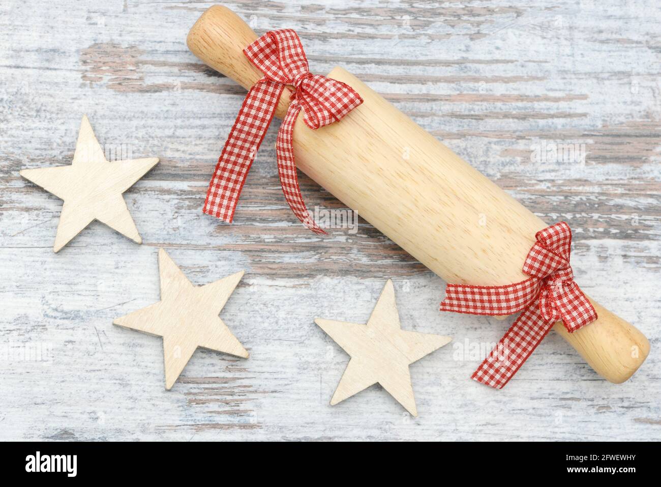 rolling pin and stars lying on wood Stock Photo