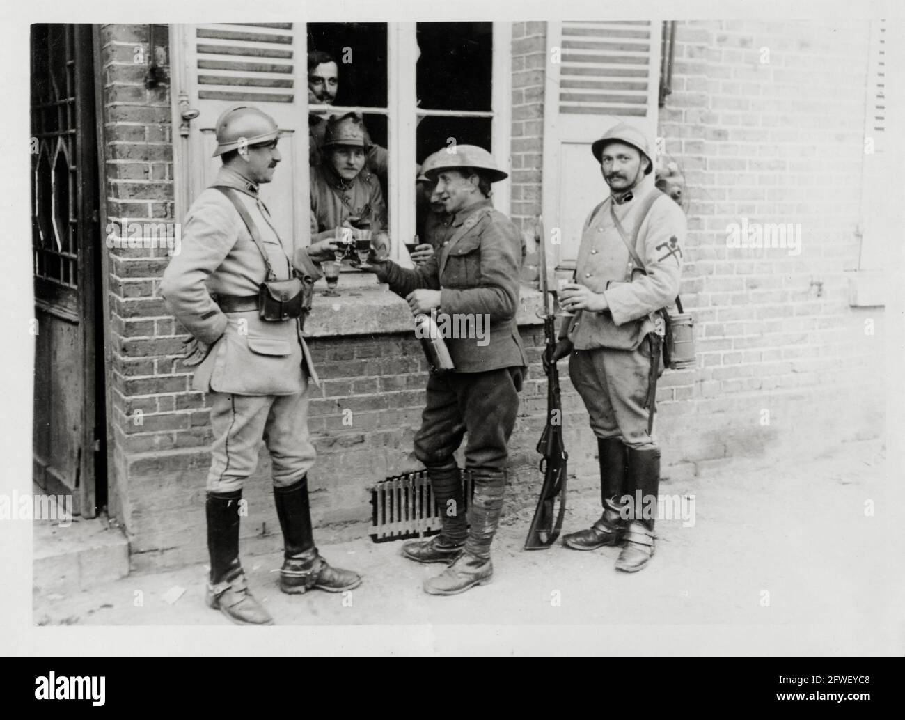 World War One, WWI, Western Front - British and French soldiers have a drink at a window, France Stock Photo