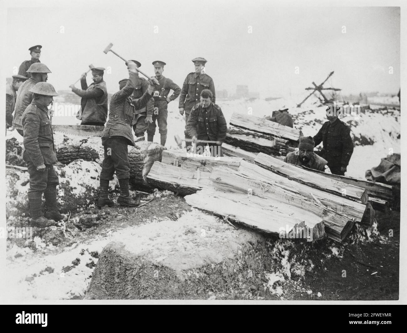 World War One, WWI, Western Front - Soldiers split logs in snow, France Stock Photo